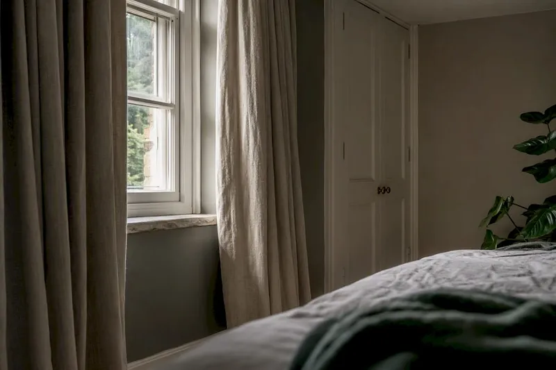 Heavy lined curtains covering UK window