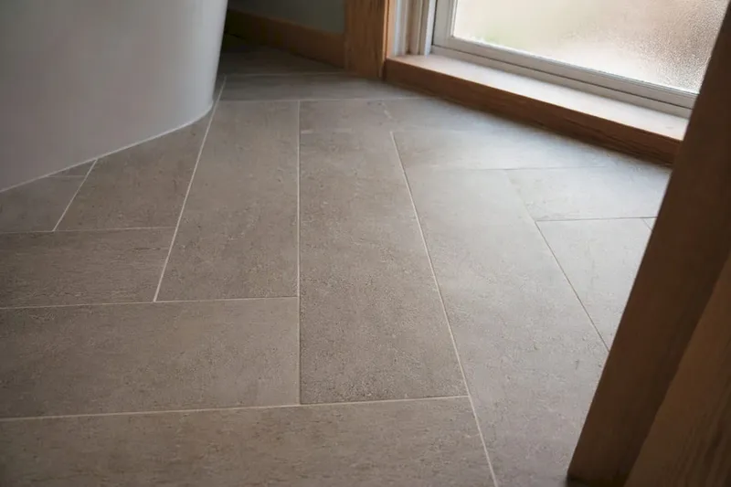 Close-up large-format tile grout joints in bathroom