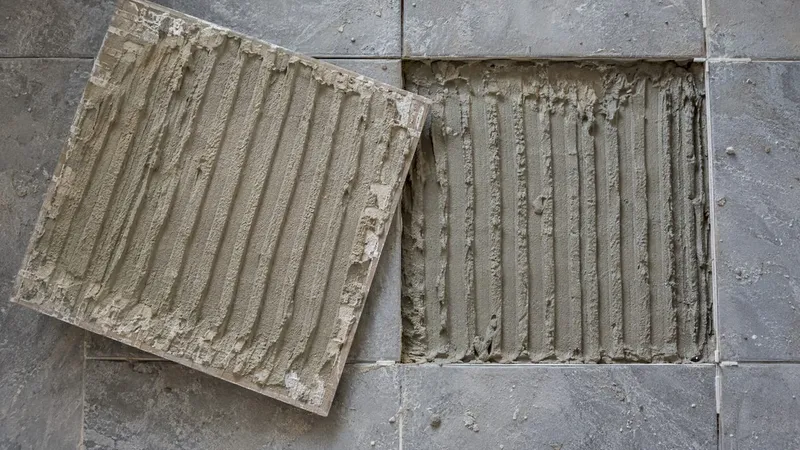 Freshly lifted tile showing mortar coverage