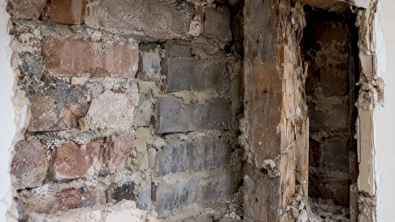 Old brickwork and timber revealed behind plaster